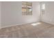 Bright bedroom features neutral carpet, large windows, and ample natural light at 5664 N 205Th Ln, Buckeye, AZ 85396