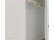 A light and bright empty closet space with a wooden closet rod at 5664 N 205Th Ln, Buckeye, AZ 85396