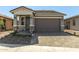 Inviting single-story home with stone accents, neutral paint, and paved driveway at 5664 N 205Th Ln, Buckeye, AZ 85396