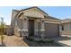 Stylish single-story home with stone details, covered porch, and well-maintained yard at 5664 N 205Th Ln, Buckeye, AZ 85396