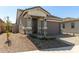 Attractive home with stone accents, covered porch, desert landscaping and paved driveway at 5664 N 205Th Ln, Buckeye, AZ 85396