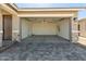 Spacious two-car garage with stone accents, leading to a driveway with pavers at 5664 N 205Th Ln, Buckeye, AZ 85396