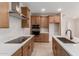 Modern kitchen featuring stainless steel appliances, wooden cabinets, and an island with a sink at 5664 N 205Th Ln, Buckeye, AZ 85396