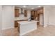 Bright kitchen boasts an island with sink, stainless steel appliances, and wooden cabinets at 5664 N 205Th Ln, Buckeye, AZ 85396
