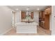 Modern kitchen featuring stainless steel appliances, island with sink, and wooden cabinets at 5664 N 205Th Ln, Buckeye, AZ 85396