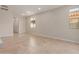 Spacious, bright living room showcasing neutral paint, tiled floors, and natural light at 5664 N 205Th Ln, Buckeye, AZ 85396