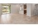 Open-concept living space with tile floors, access to the patio, and a kitchen counter at 5664 N 205Th Ln, Buckeye, AZ 85396