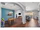 Open-concept living room featuring hardwood floors, arched doorways, and modern design elements at 2412 W Crimson Ter, Phoenix, AZ 85085
