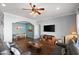 Comfortable living room with hardwood floors, ceiling fan, and a view of the adjacent dining area at 2412 W Crimson Ter, Phoenix, AZ 85085