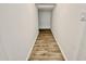 Long hallway with light walls and wood-look flooring at 746 E Doral Ave # 201, Gilbert, AZ 85297