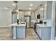 Spacious kitchen featuring white cabinets, a large island and stainless steel appliances at 746 E Doral Ave # 201, Gilbert, AZ 85297