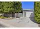 Contemporary home featuring modern garage door, concrete tile driveway, and mature landscaping at 8614 E Berridge Ln, Scottsdale, AZ 85250