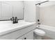 Bright bathroom featuring a modern vanity with matte black hardware and a tub-shower combo with marble-style tiling at 16555 N Lunar St, Maricopa, AZ 85138