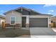 Charming single-story home with a two-car garage and stylish stone accents on the facade at 16555 N Lunar St, Maricopa, AZ 85138