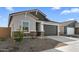This is a single-story home with desert landscaping and a gray-colored 2-car garage at 16555 N Lunar St, Maricopa, AZ 85138