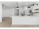 Bright kitchen with stainless steel appliances, white cabinets, and a spacious quartz countertop island at 16555 N Lunar St, Maricopa, AZ 85138