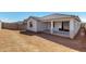 Spacious backyard featuring a covered patio with modern columns at 18440 W Monte Lindo Ln, Surprise, AZ 85387