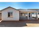 Backyard view of covered patio and stucco exterior of home at 18440 W Monte Lindo Ln, Surprise, AZ 85387