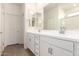Bright bathroom with double vanity, quartz countertop, modern fixtures, and wood look tile flooring at 18440 W Monte Lindo Ln, Surprise, AZ 85387