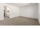 Bedroom features carpet floors and a door to the en-suite bathroom at 18440 W Monte Lindo Ln, Surprise, AZ 85387