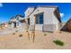 A clean shot of the exterior corner of a modern-style home with desert-style landscaping at 18440 W Monte Lindo Ln, Surprise, AZ 85387