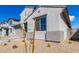 The exterior view of a modern home is showcased with its simple desert landscaping at 18440 W Monte Lindo Ln, Surprise, AZ 85387
