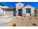 Charming single-story home featuring a low-maintenance desert landscape and a two-car garage at 18440 W Monte Lindo Ln, Surprise, AZ 85387