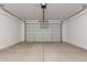 Large two-car garage with automatic door and bright lighting at 18440 W Monte Lindo Ln, Surprise, AZ 85387