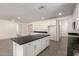 Spacious kitchen and eating area has an island and stainless steel appliances at 18440 W Monte Lindo Ln, Surprise, AZ 85387