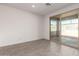 Bright living room showing a sliding door to the backyard with a view of the block wall at 18440 W Monte Lindo Ln, Surprise, AZ 85387