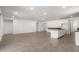 This bright and open living room has tiled floors and is attached to the kitchen at 18440 W Monte Lindo Ln, Surprise, AZ 85387