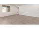Bright living room featuring tile floors, natural light, and neutral wall paint at 18440 W Monte Lindo Ln, Surprise, AZ 85387