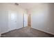 Spacious bedroom with neutral carpet, white trim, and ample natural light at 35315 W La Paz St, Maricopa, AZ 85138