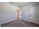 Neutrally colored carpeted bedroom with two doors at 35315 W La Paz St, Maricopa, AZ 85138