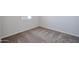 Neutral carpet lines this room that includes a window at 35315 W La Paz St, Maricopa, AZ 85138