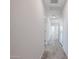Bright hallway with gray wood-look tile flooring leads to various rooms at 35315 W La Paz St, Maricopa, AZ 85138