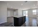 Open concept kitchen with a granite island, seamlessly connected to the spacious living area at 35315 W La Paz St, Maricopa, AZ 85138