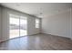 Bright living room with sliding glass doors, creating a seamless indoor-outdoor flow to the backyard at 35315 W La Paz St, Maricopa, AZ 85138