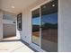 A covered patio with a sliding glass door offers indoor-outdoor living space at 35315 W La Paz St, Maricopa, AZ 85138