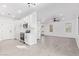 Modern kitchen flows into the living room, featuring stainless steel appliances, white cabinetry, and light floors at 4130 W Irwin Ave, Phoenix, AZ 85041