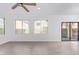 Bright living room with light flooring, white walls, a ceiling fan, and large windows for natural lighting at 4130 W Irwin Ave, Phoenix, AZ 85041