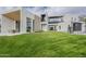 Modern home with a well-maintained lawn, outdoor seating, and sleek architectural design with black framed windows at 4414 N 29Th St, Phoenix, AZ 85016