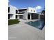 Modern home with a sleek pool, concrete patio, green grass, and a contemporary architectural design at 4414 N 29Th St, Phoenix, AZ 85016