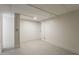 Clean basement with gray tile flooring and painted walls, ready for customization into a functional space at 4414 N 29Th St, Phoenix, AZ 85016