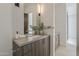 Modern bathroom vanity area with wood cabinets, neutral countertop, and stylish fixtures at 4414 N 29Th St, Phoenix, AZ 85016