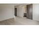 Open bedroom with hardwood floors, barn door to the en suite bathroom, and lots of natural light at 4414 N 29Th St, Phoenix, AZ 85016