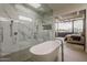 Bright and spacious main bathroom connects to bedroom with a soaking tub and glass shower at 4414 N 29Th St, Phoenix, AZ 85016