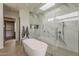 Sleek bathroom showcasing a soaking tub, walk-in shower with glass enclosure, and private entrance at 4414 N 29Th St, Phoenix, AZ 85016