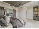 Modern main bedroom featuring stylish chandelier, barn door to bathroom, and a beverage bar at 4414 N 29Th St, Phoenix, AZ 85016