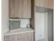 Elegant laundry room featuring modern cabinetry, quartz countertop, and stylish decor at 4414 N 29Th St, Phoenix, AZ 85016